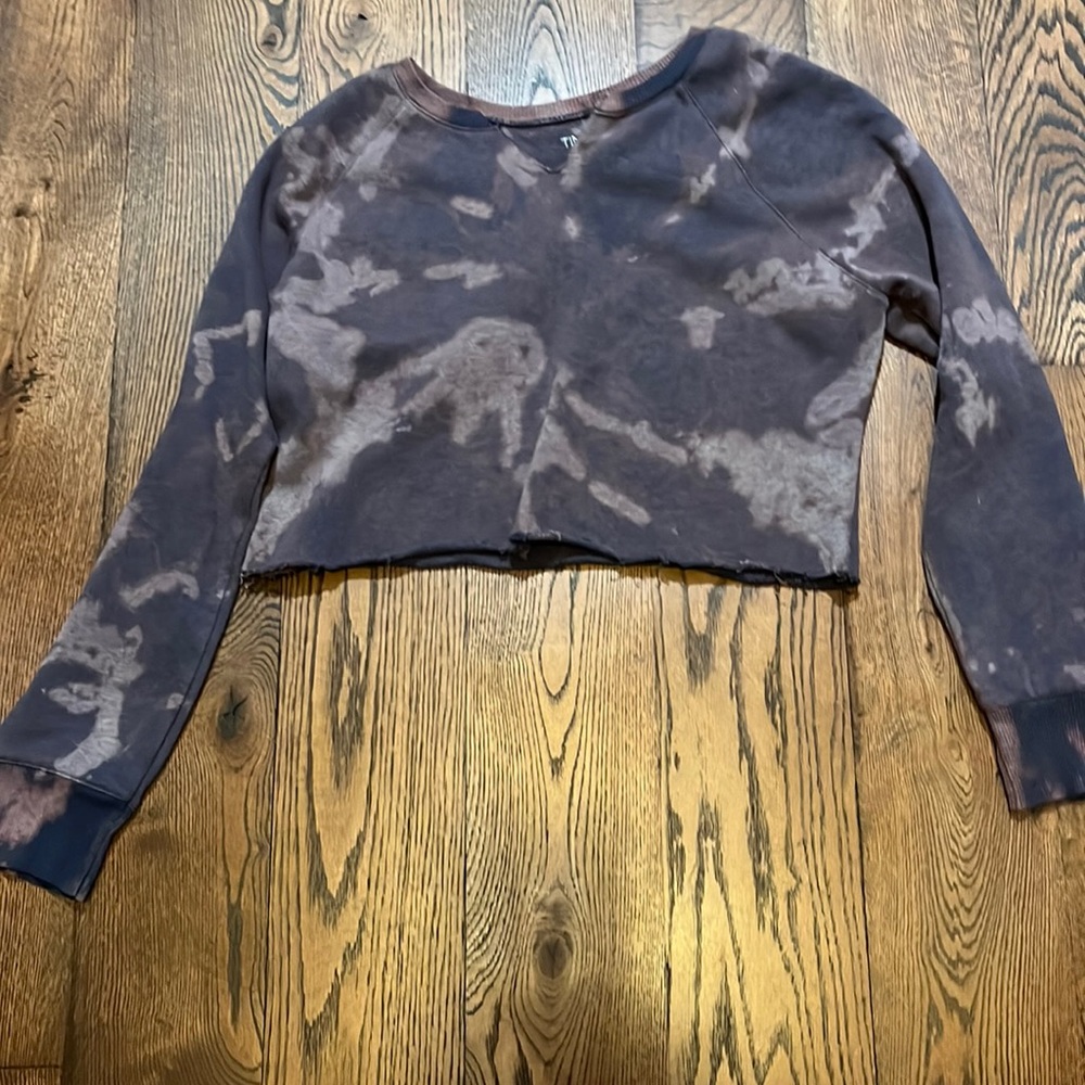 A cropped sweater with rolled ends, and a slit at the top